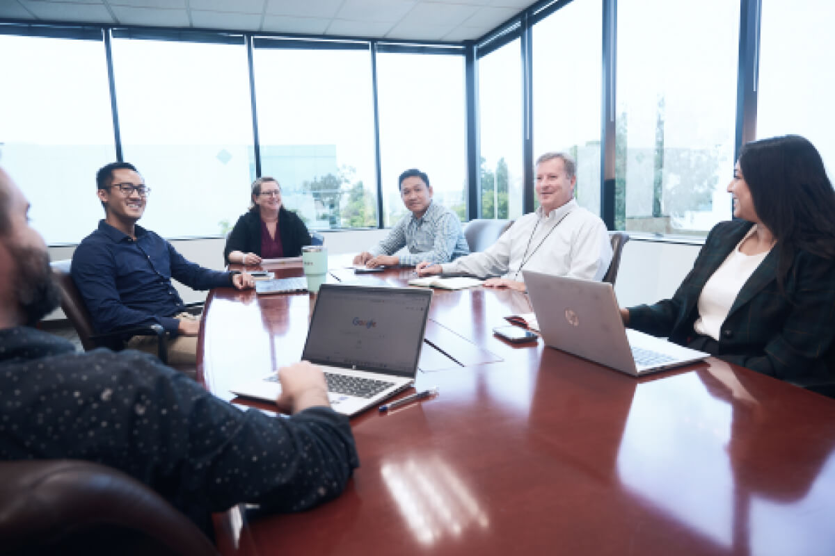 Photo of team members in a board room representing project management services
