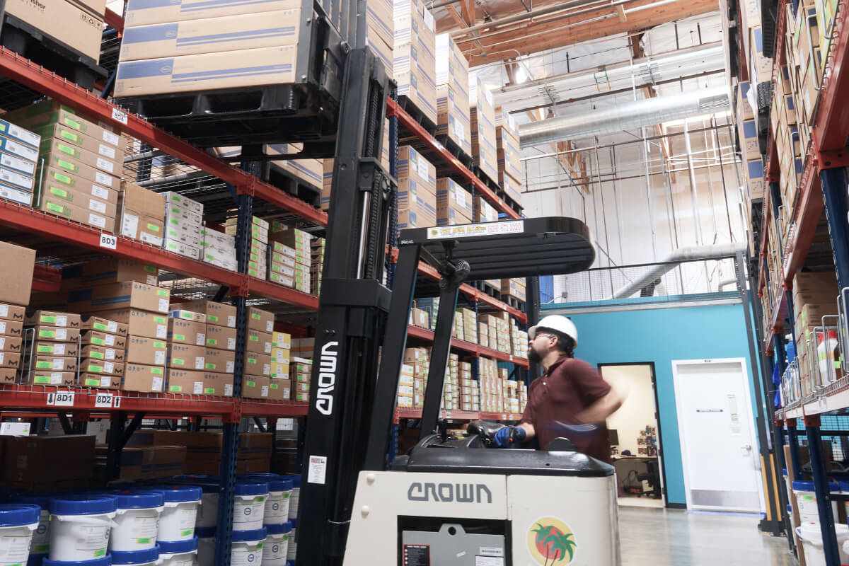 Photo of a worker operating a forklift truck in a warehouse